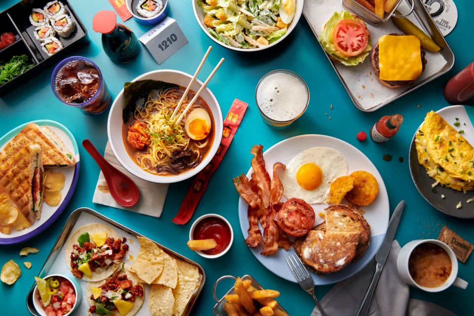 a table topped with plates of food and a sign that says 1210