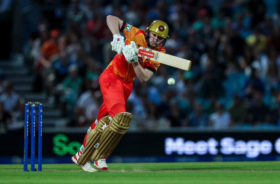 a cricket player swings his bat in front of a sign that says meet sage