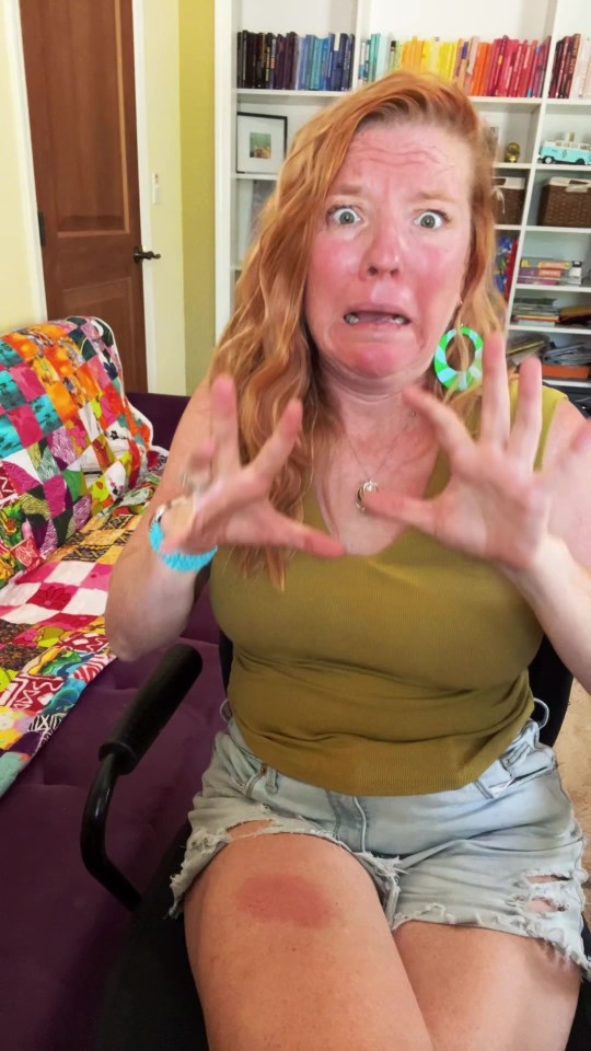 a woman making a funny face while sitting on a chair