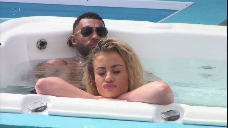 a man and a woman are laying in a hot tub on channel 5