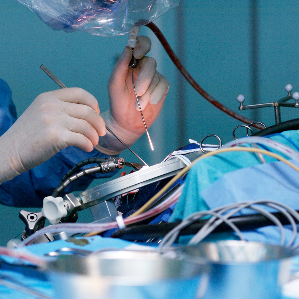 a surgeon is operating on a patient in an operating room