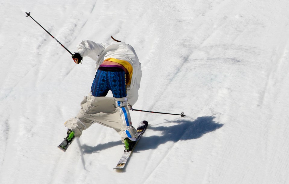 a person is skiing down a snowy slope and their pants are visible