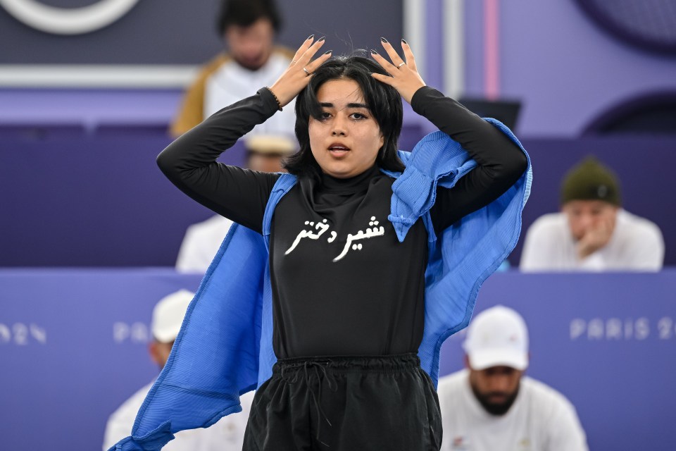 a woman wearing a black shirt with arabic writing on it