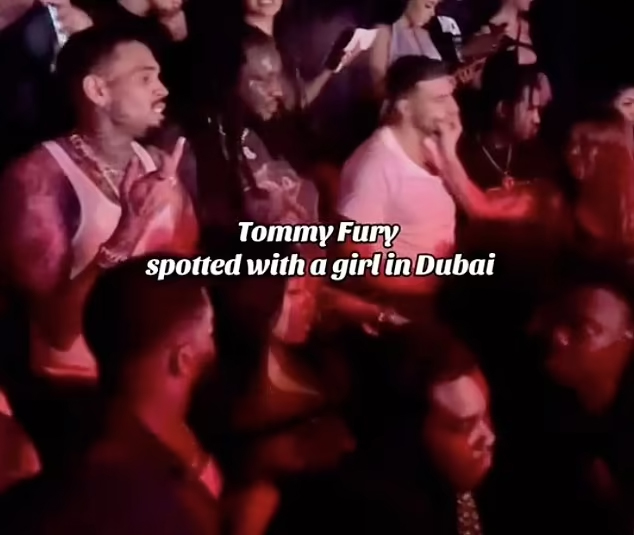 Tommy Fury had his face squeezed by a female reveller as he partied in Dubai