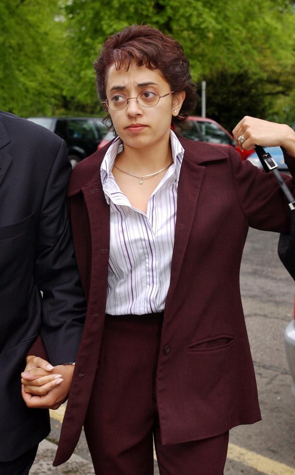 a woman in a suit holds hands with a man in a suit