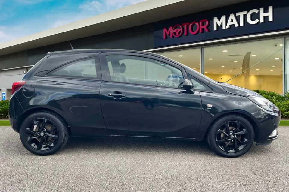 a black car is parked in front of a motor match store