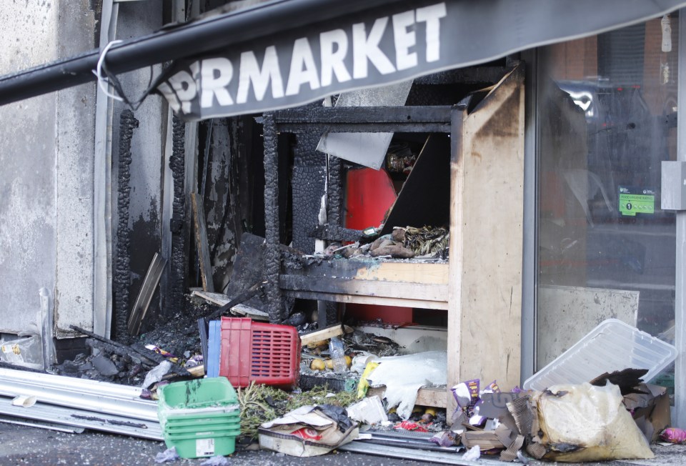 a damaged store front with a sign that says market