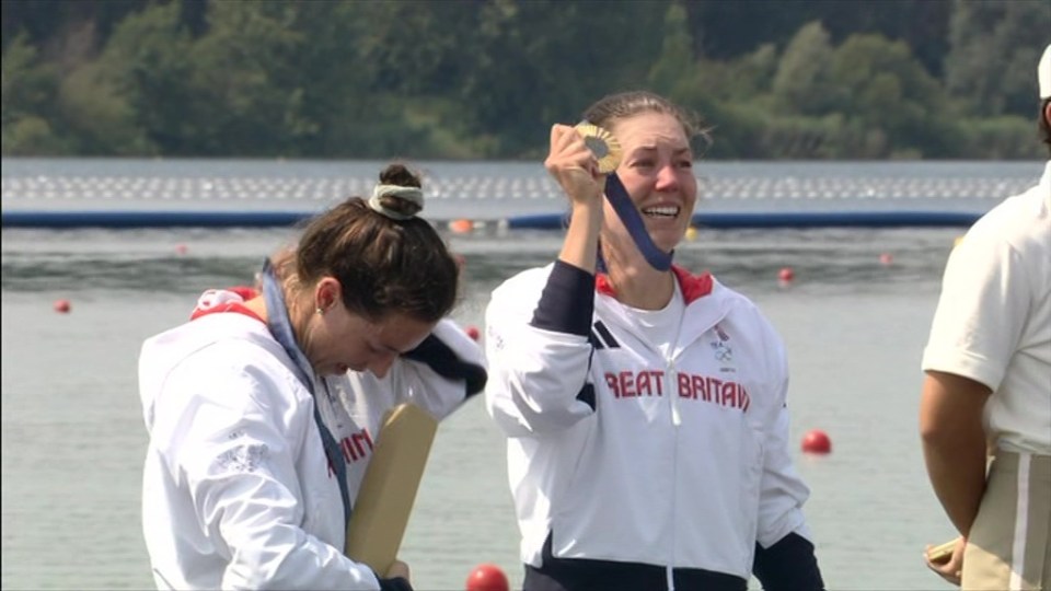 Before lifting her medal to fans in Paris