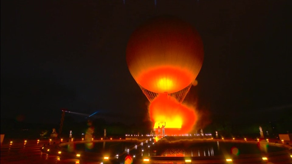 a large hot air balloon is lit up at night