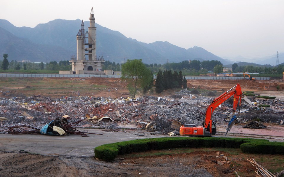 a large pile of rubble with a castle in the background