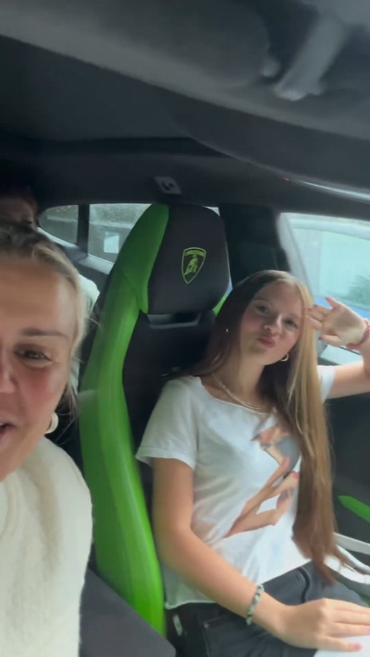 two girls are sitting in a green lamborghini car