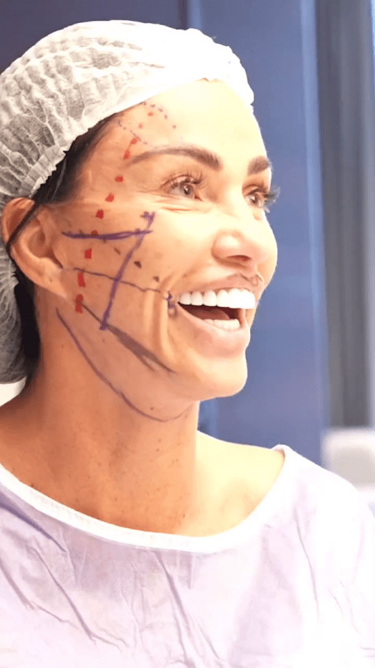 a woman with lines drawn on her face is smiling