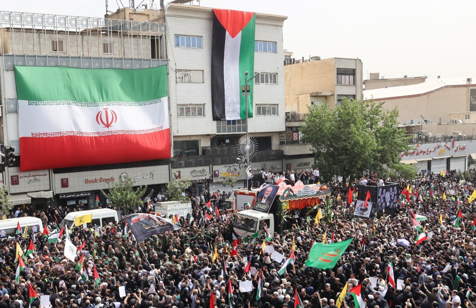 Iranians attend the funeral procession of the assassinated Hamas chief in Tehran