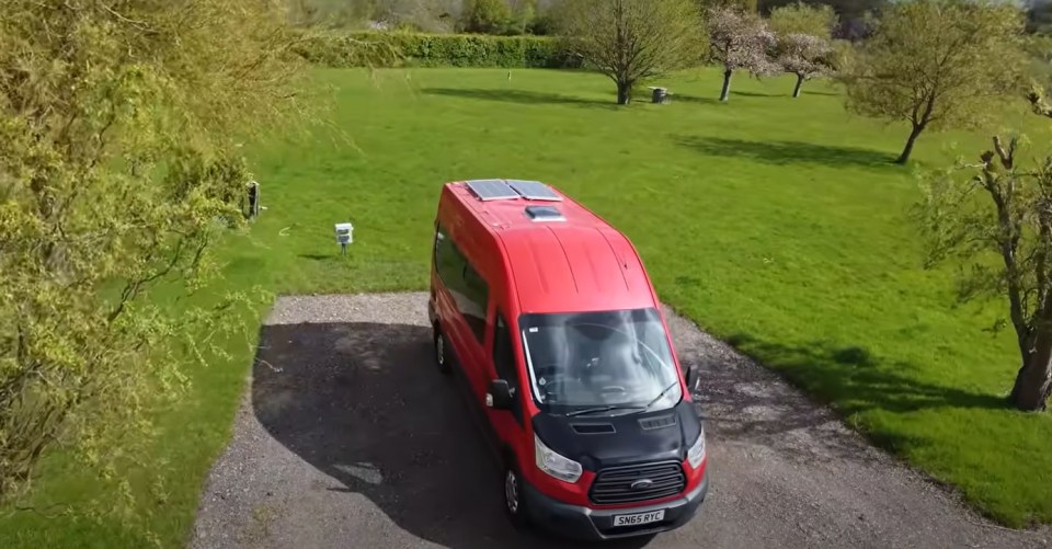 a red van with a license plate that says sn65 jfd