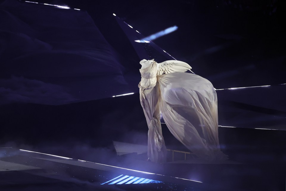 a statue of a woman with wings in a dark room