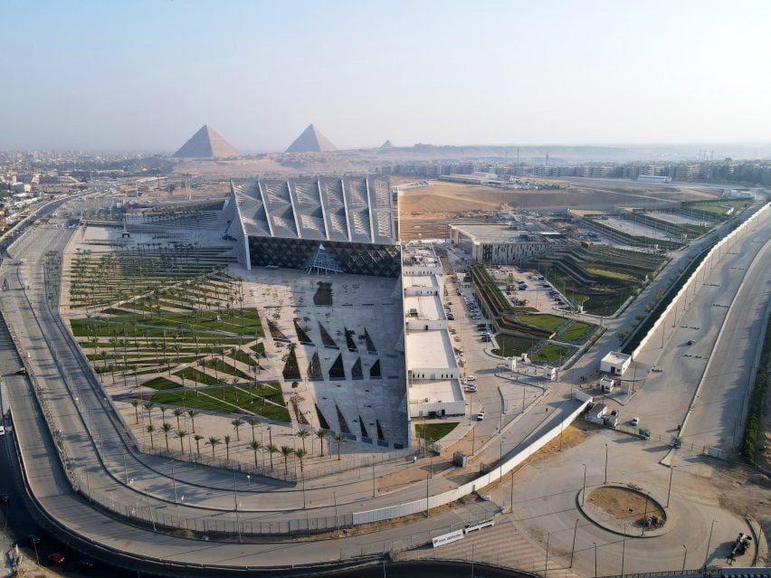 An aerial picture of The Grand Egyptian Museum showing the Giza pyramids in the background