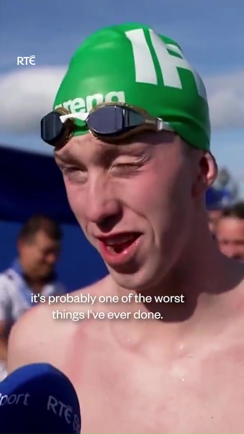 a man wearing a green swim cap with the number 15 on it