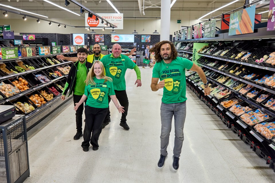 a man wearing a green shirt that says you scan we donate