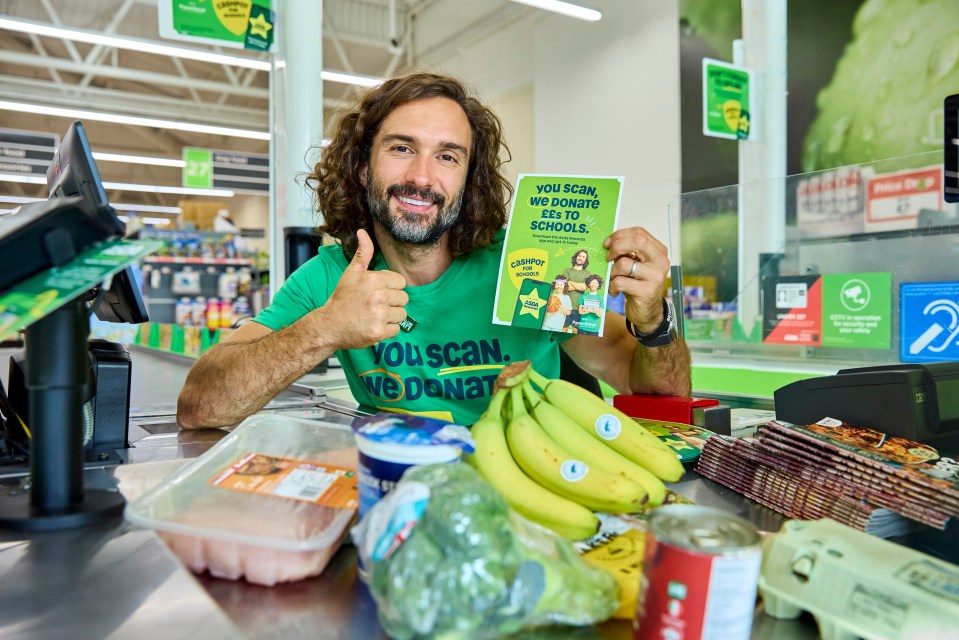 a man in a green shirt that says you scan we donate giving a thumbs up