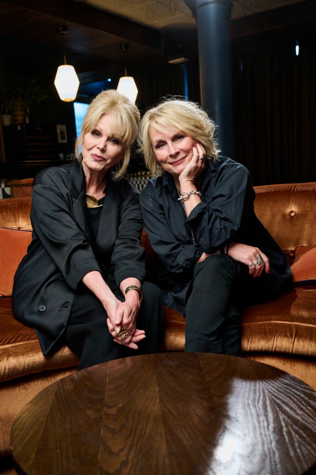 two women sitting next to each other on a couch