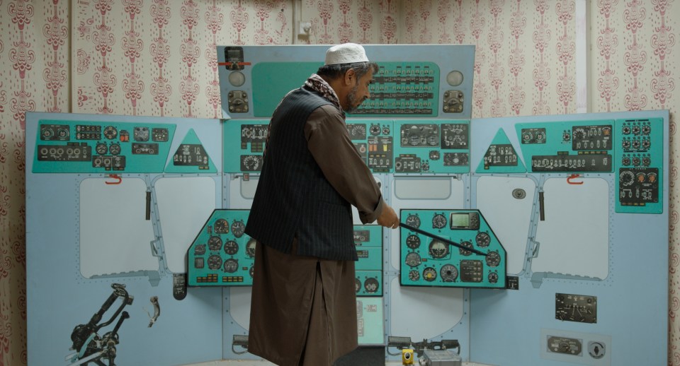 a man stands in front of a control panel that says ' a ' on it