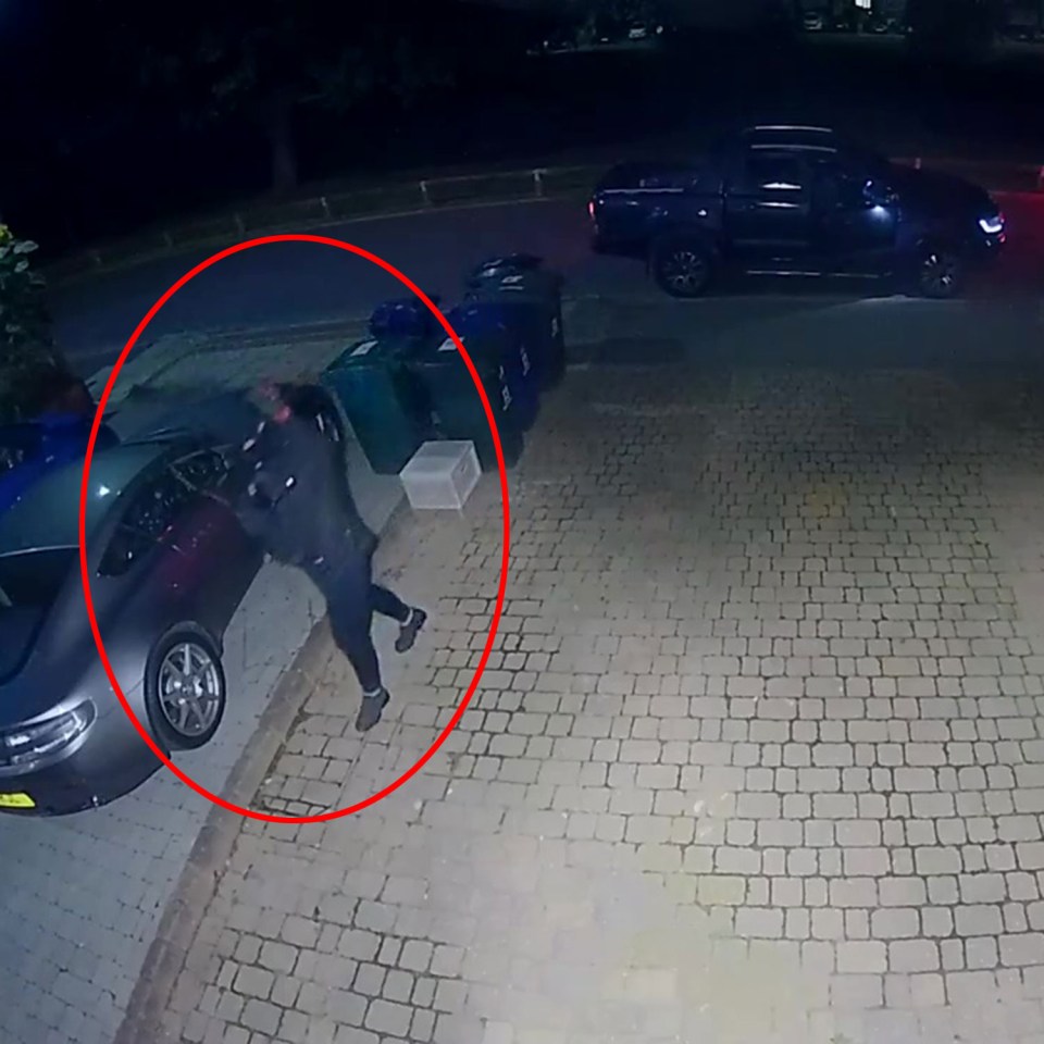 a man is standing in front of a car with a red circle around him