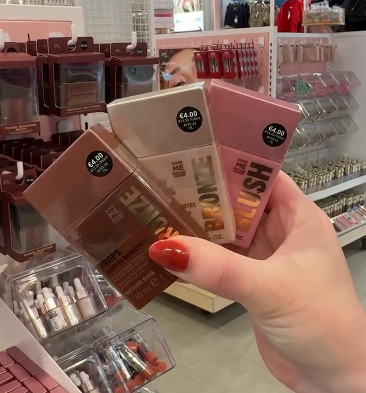 a woman is holding a box of blush in her hand