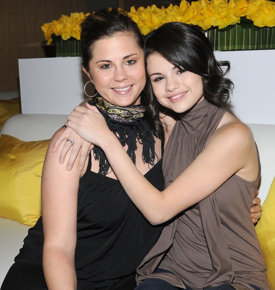 two women are posing for a picture and one has a ring on her finger