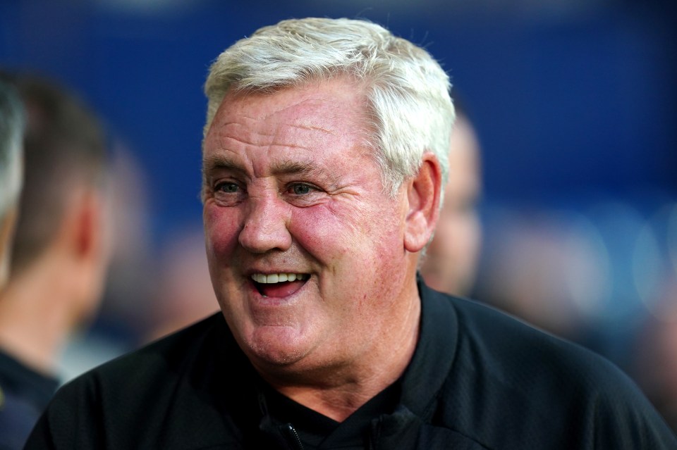 a man with white hair is smiling and wearing a black shirt