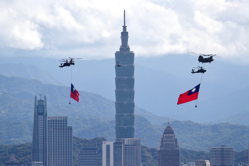 a few helicopters are flying over a city with mountains in the background