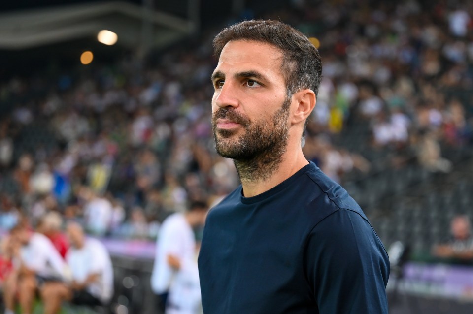 a man in a blue shirt stands in front of a crowd