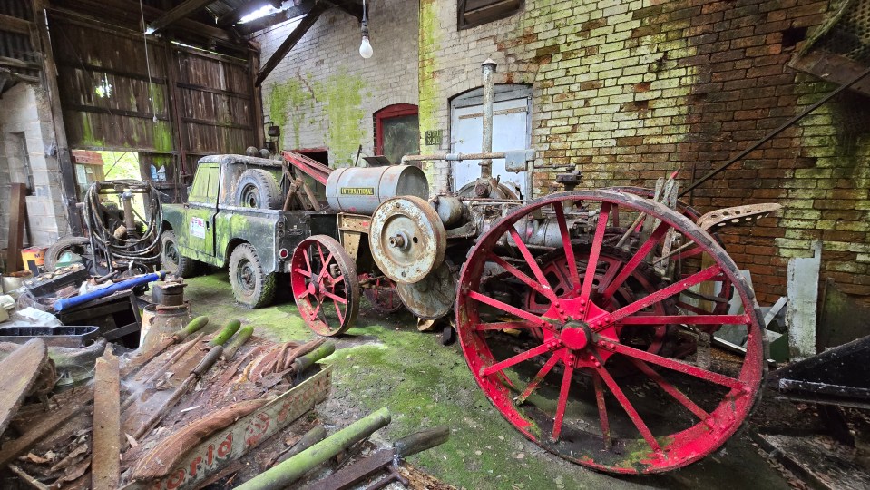 a tow truck is parked next to a tractor that says ' williams ' on it