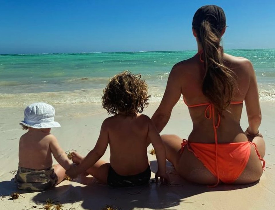 Lauryn pictured enjoying a beach holiday with her and Kyle's two kids