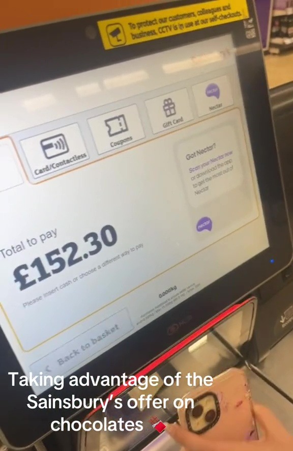 a person is taking advantage of the sainsbury 's offer on chocolates