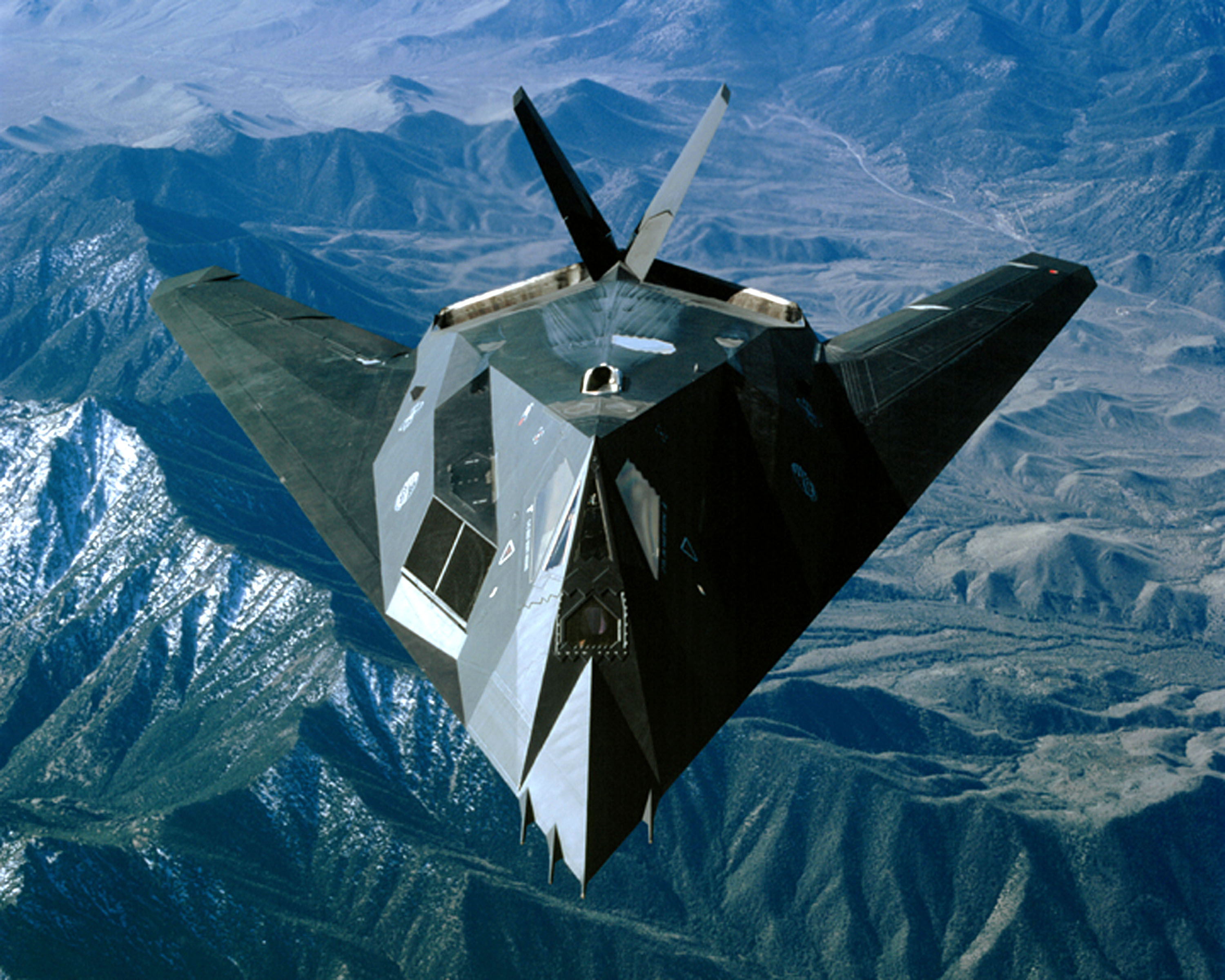 An F-117 Nighthawk flies over the Sierra Nevada Mountain Range