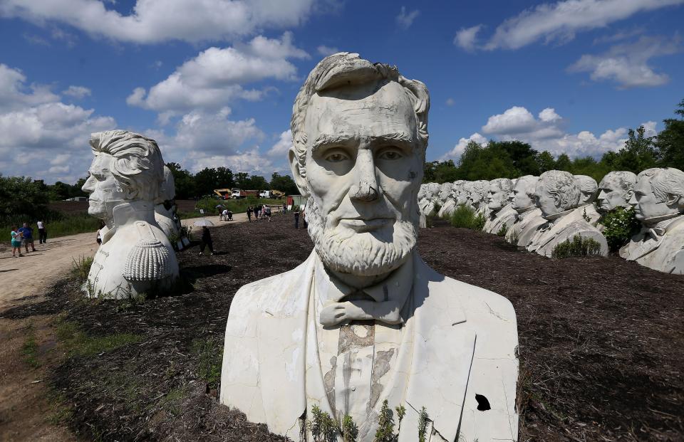 a statue of abraham lincoln is surrounded by other statues