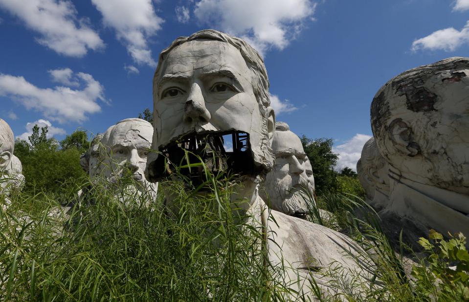 a statue of abraham lincoln is surrounded by other statues