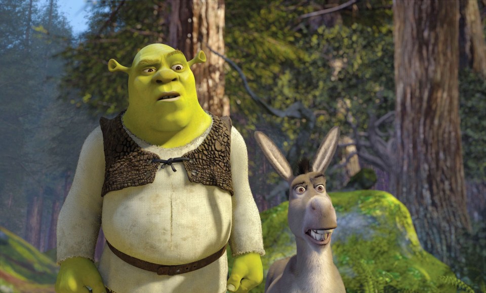 shrek and donkey standing next to each other in the woods