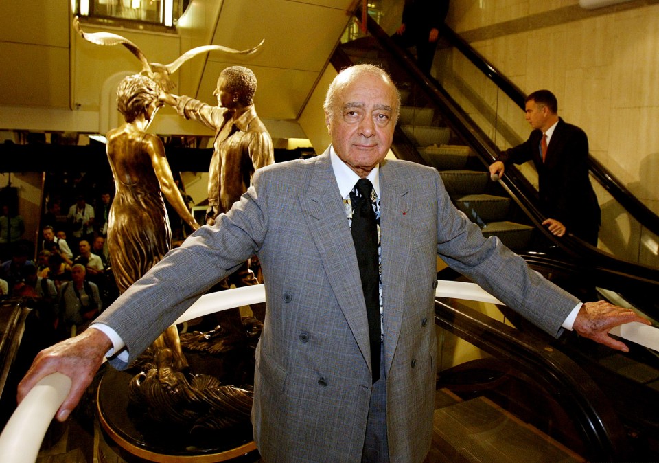 a man in a suit and tie stands in front of a statue