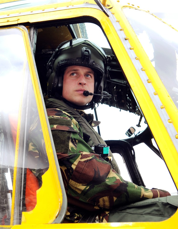 a man in a camouflage uniform is sitting in the cockpit of a helicopter