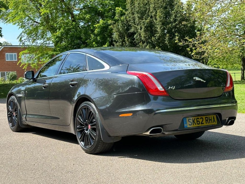 a jaguar car with a license plate that says sk62 rha