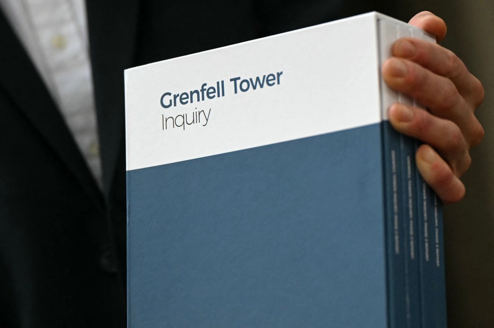 a person holding a book titled grenfell tower inquiry