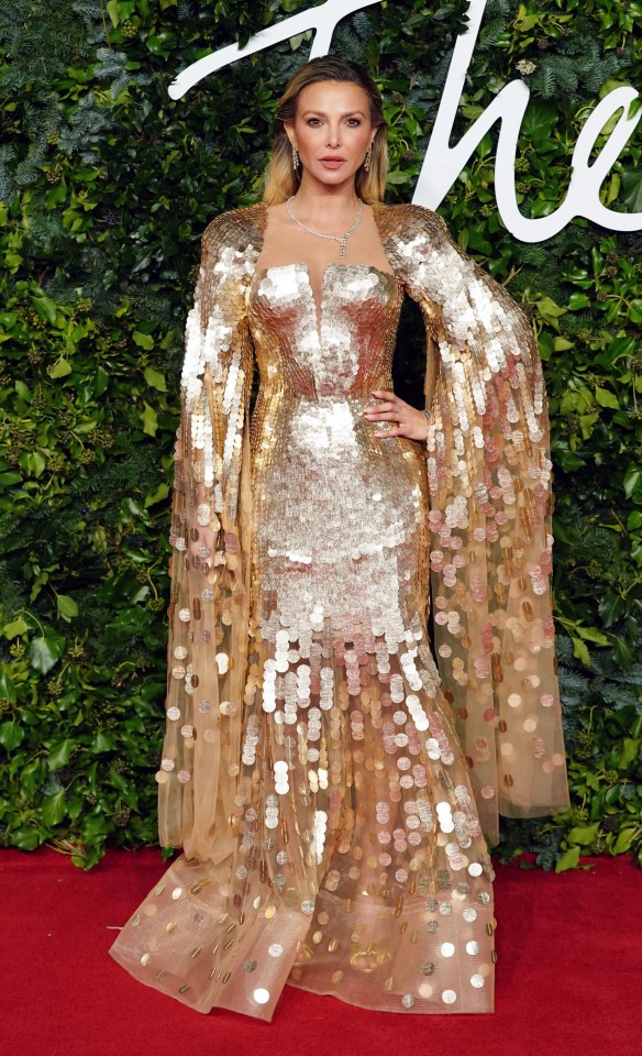 a woman stands on a red carpet with the word the on it