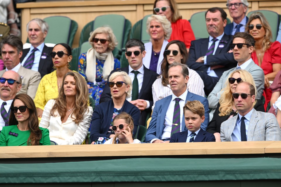 a group of people wearing sunglasses sit in a stadium