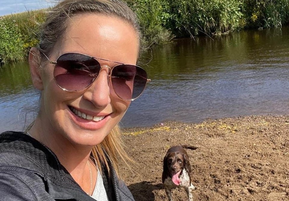 a woman wearing sunglasses is standing next to a brown dog