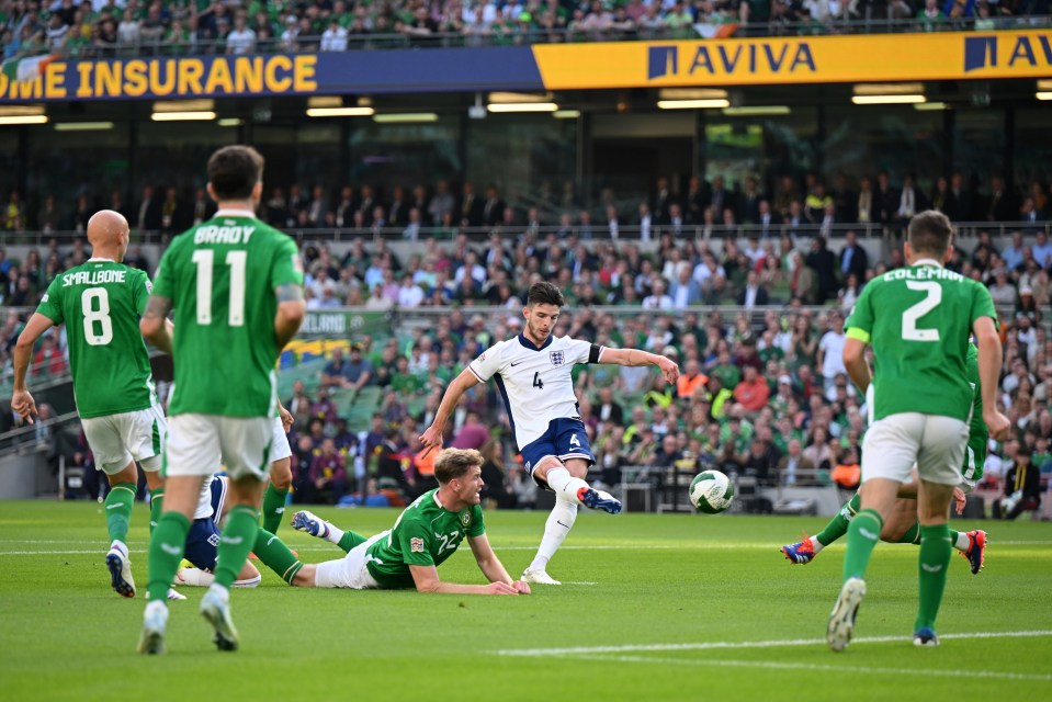 soccer players on a field with an ad for aviva in the background