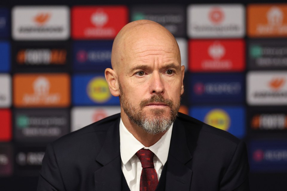 a bald man with a beard wearing a suit and tie