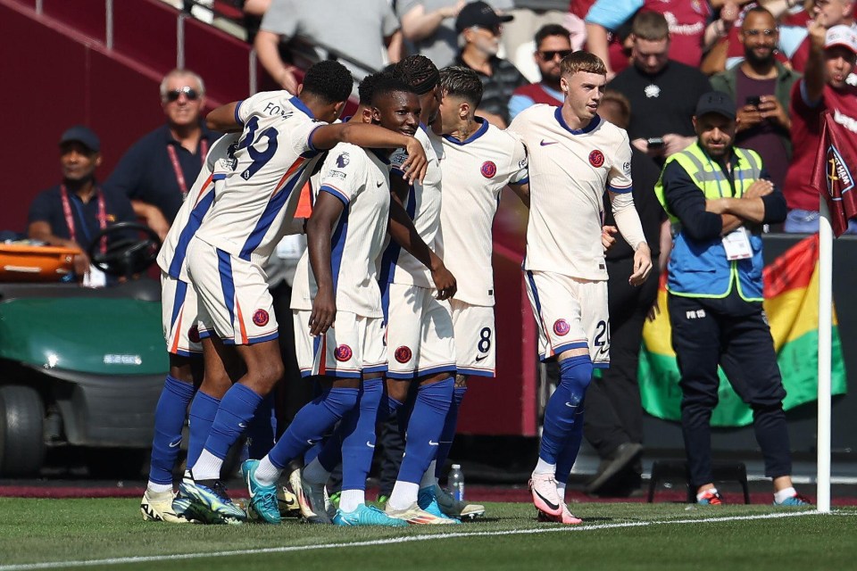 a group of soccer players celebrate a goal with one wearing the number 9