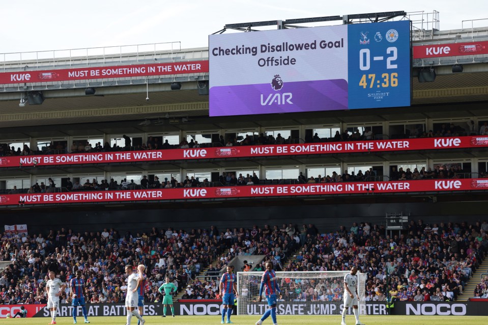 a scoreboard at a soccer game says checking disallowed goal offside