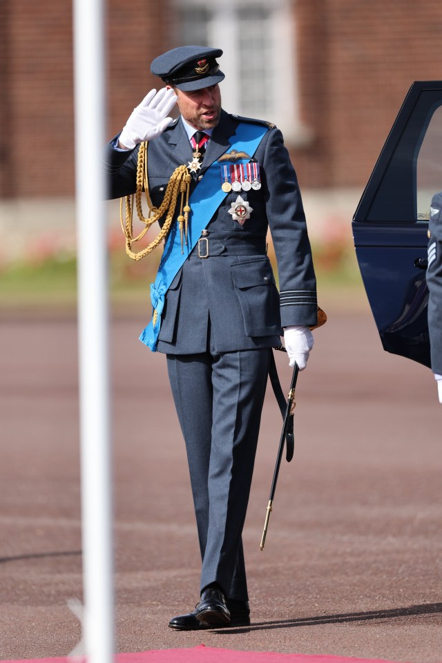 a man in a military uniform salutes while holding a cane